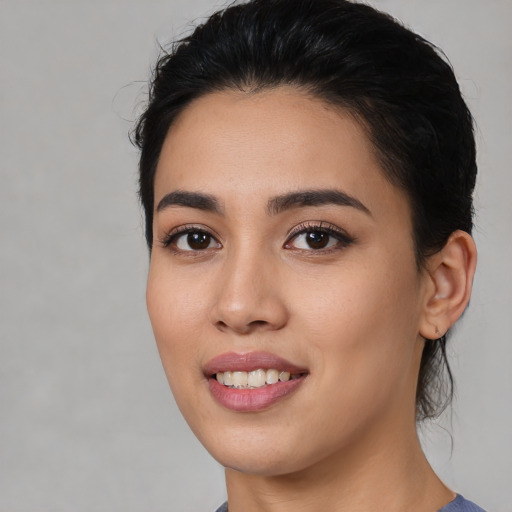 Joyful white young-adult female with medium  black hair and brown eyes