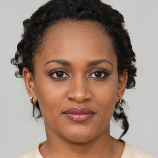 Joyful black young-adult female with medium  brown hair and brown eyes