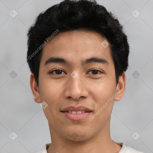 Joyful asian young-adult male with short  black hair and brown eyes