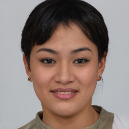 Joyful asian young-adult female with short  brown hair and brown eyes