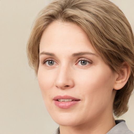 Joyful white young-adult female with medium  brown hair and green eyes