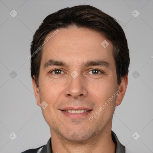 Joyful white adult male with short  black hair and brown eyes