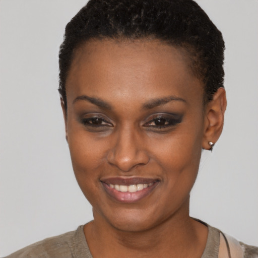 Joyful black young-adult female with short  brown hair and brown eyes