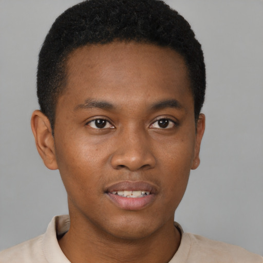 Joyful black young-adult male with short  brown hair and brown eyes