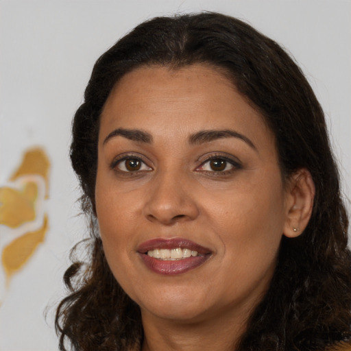 Joyful black young-adult female with medium  brown hair and brown eyes