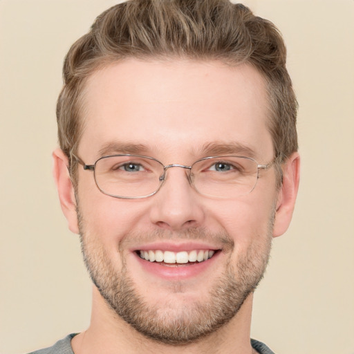 Joyful white adult male with short  brown hair and grey eyes