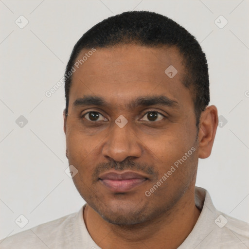 Joyful black young-adult male with short  black hair and brown eyes