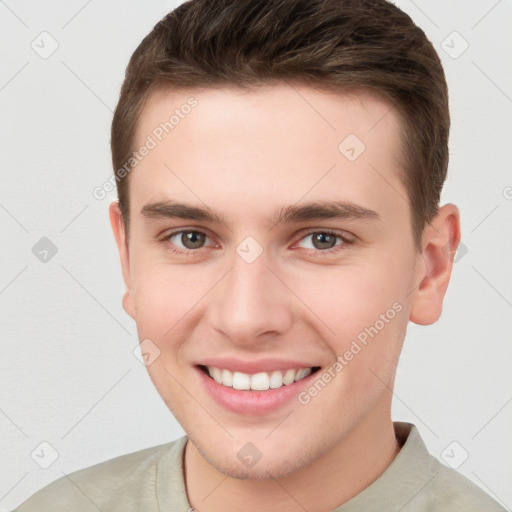 Joyful white young-adult male with short  brown hair and grey eyes