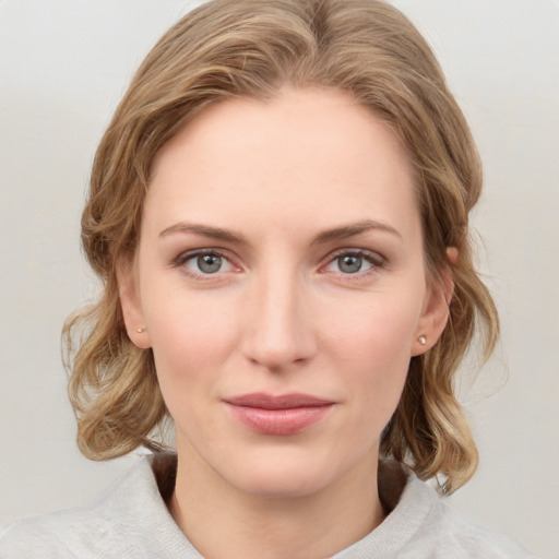 Joyful white young-adult female with medium  brown hair and blue eyes