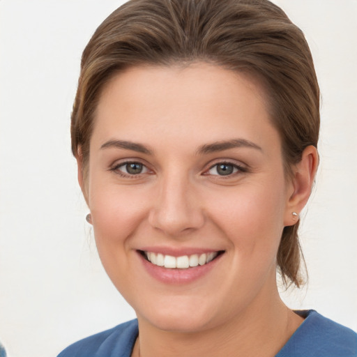 Joyful white young-adult female with medium  brown hair and grey eyes