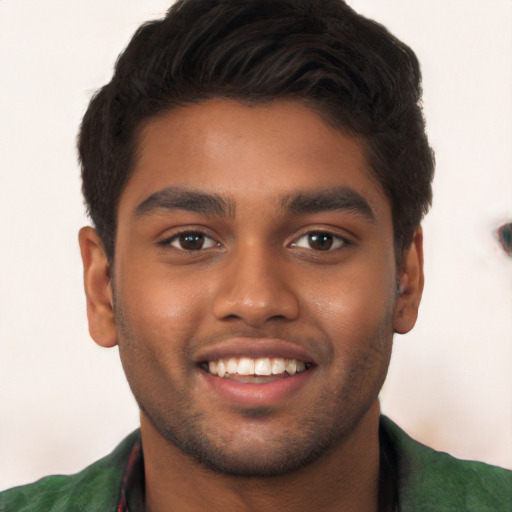 Joyful black young-adult male with short  brown hair and brown eyes