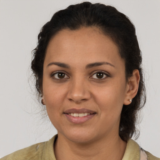 Joyful latino young-adult female with medium  brown hair and brown eyes