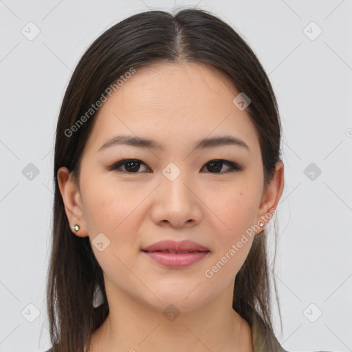 Joyful asian young-adult female with long  brown hair and brown eyes