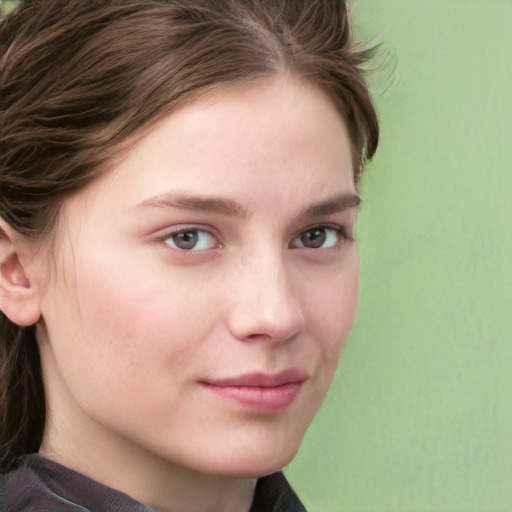 Joyful white young-adult female with long  brown hair and blue eyes