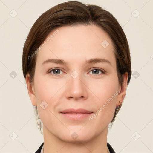 Joyful white young-adult female with short  brown hair and grey eyes