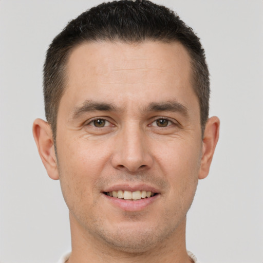 Joyful white young-adult male with short  brown hair and brown eyes