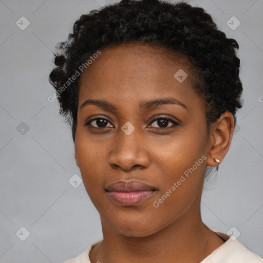 Joyful black young-adult female with short  black hair and brown eyes