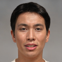 Joyful asian young-adult male with short  brown hair and brown eyes