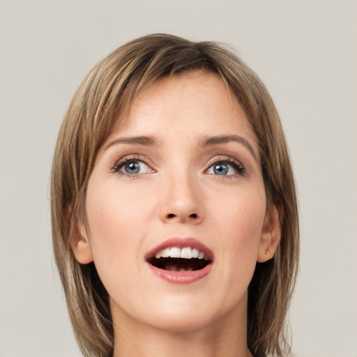 Joyful white young-adult female with medium  brown hair and green eyes