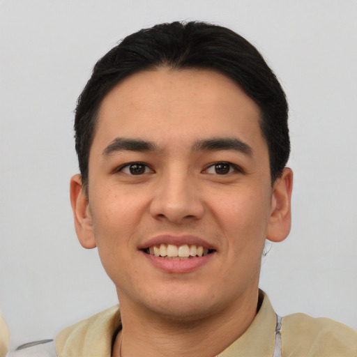 Joyful asian young-adult male with short  black hair and brown eyes
