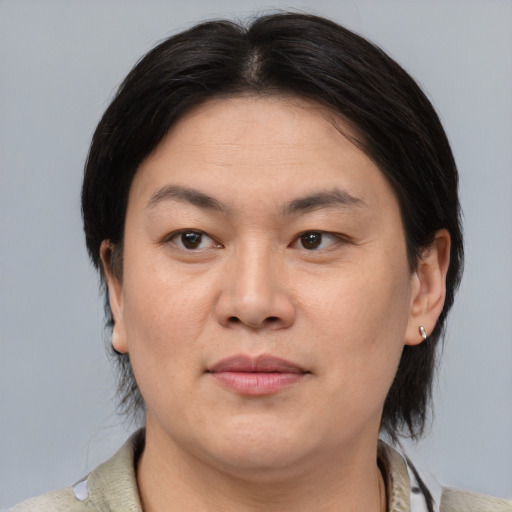 Joyful asian adult female with medium  brown hair and brown eyes