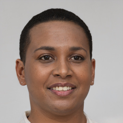 Joyful black young-adult female with short  brown hair and brown eyes