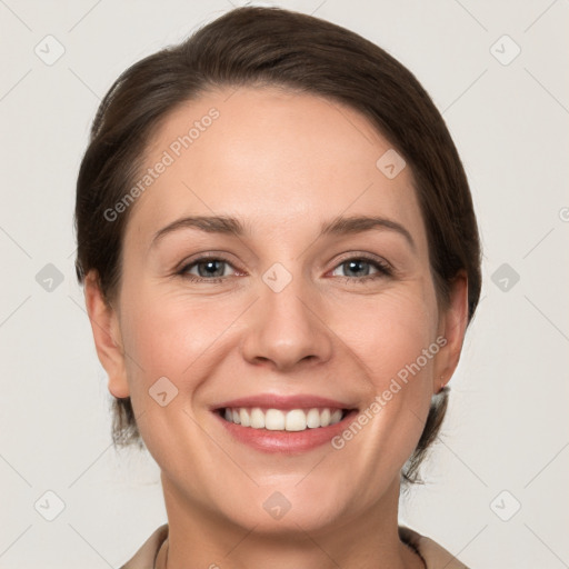 Joyful white young-adult female with medium  brown hair and grey eyes