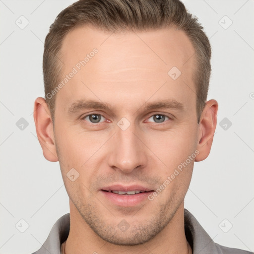 Joyful white young-adult male with short  brown hair and grey eyes