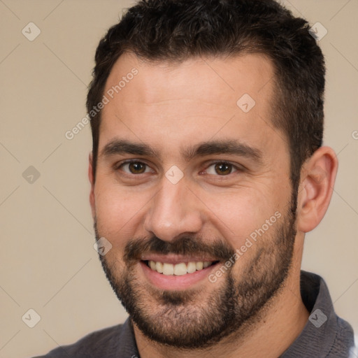 Joyful white young-adult male with short  brown hair and brown eyes