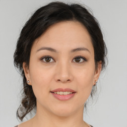 Joyful asian young-adult female with medium  brown hair and brown eyes