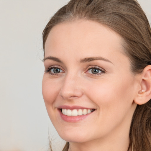 Joyful white young-adult female with long  brown hair and grey eyes