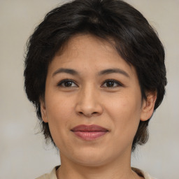 Joyful asian adult female with medium  brown hair and brown eyes