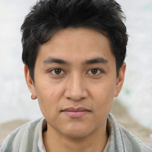 Joyful asian young-adult male with short  brown hair and brown eyes