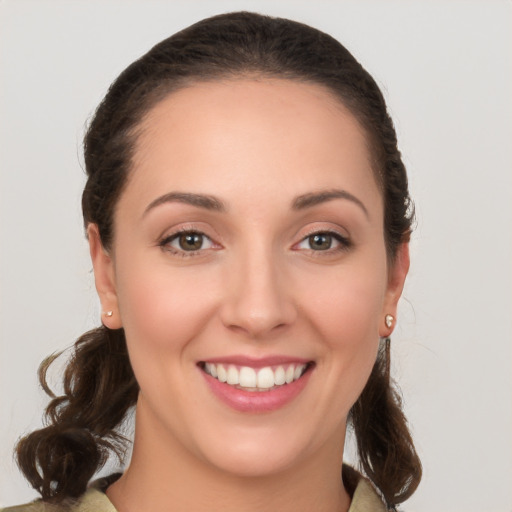 Joyful white young-adult female with medium  brown hair and brown eyes