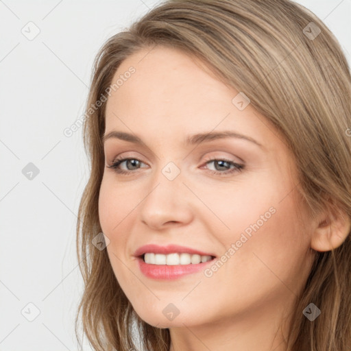 Joyful white young-adult female with long  brown hair and grey eyes