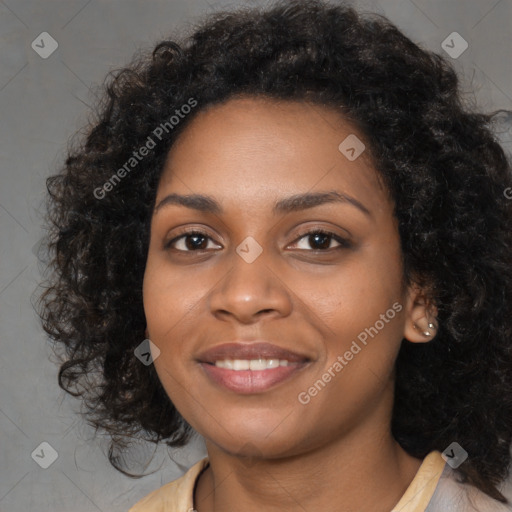 Joyful black young-adult female with long  black hair and brown eyes