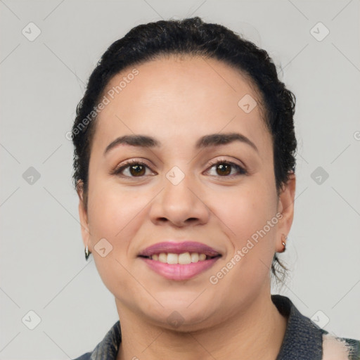 Joyful latino young-adult female with short  black hair and brown eyes