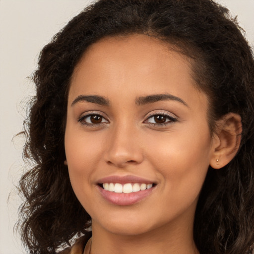 Joyful white young-adult female with long  brown hair and brown eyes