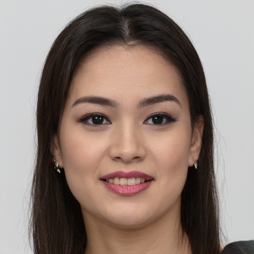 Joyful latino young-adult female with long  brown hair and brown eyes