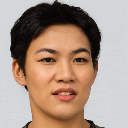 Joyful asian young-adult female with short  black hair and brown eyes