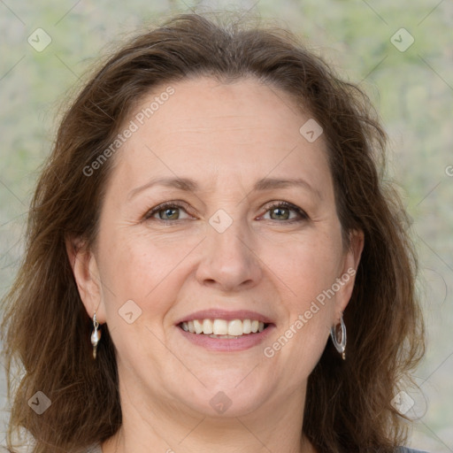 Joyful white adult female with long  brown hair and grey eyes