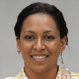 Joyful black adult female with short  brown hair and brown eyes