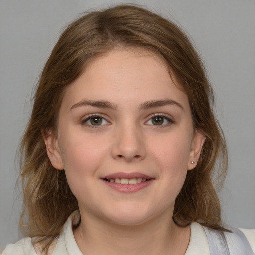 Joyful white child female with medium  brown hair and brown eyes