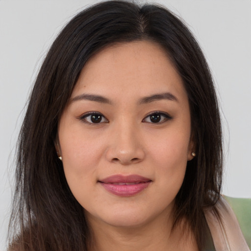 Joyful asian young-adult female with long  brown hair and brown eyes