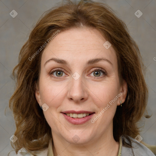 Joyful white adult female with medium  brown hair and blue eyes