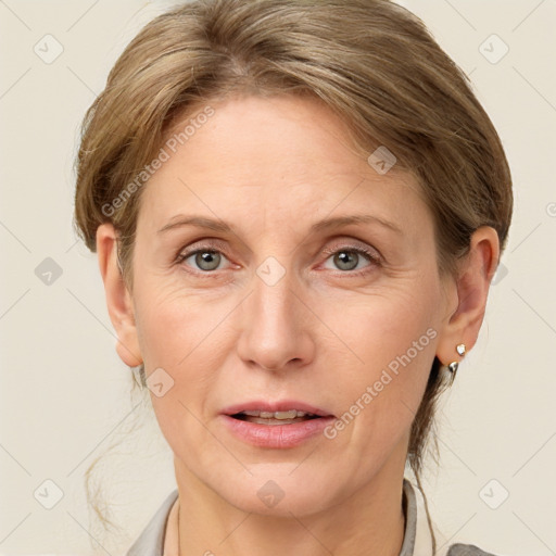 Joyful white adult female with medium  brown hair and grey eyes