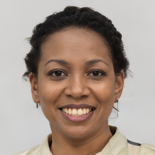 Joyful latino young-adult female with short  brown hair and brown eyes