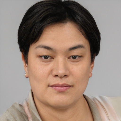 Joyful asian young-adult female with short  brown hair and brown eyes