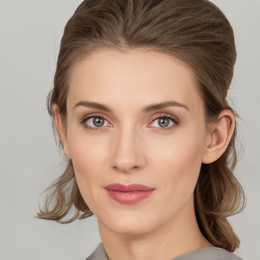 Joyful white young-adult female with medium  brown hair and grey eyes