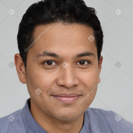 Joyful latino young-adult male with short  brown hair and brown eyes